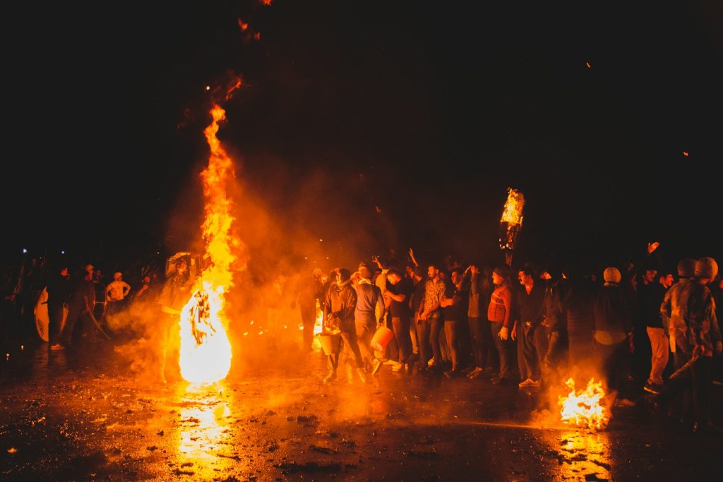 A group of people standing around a fire